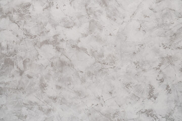 Background of light gray putty or textured gypsum plaster with white stains on the wall.