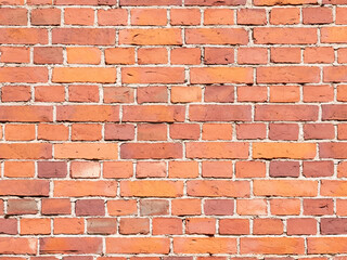 Old red brick wall background texture. Grungy red brick blank wall texture. Retro house facade. Distressed stonewall surface.