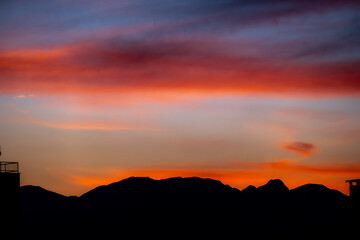 Sunset mountain peaks silhouette. Mountain sunset sky clouds