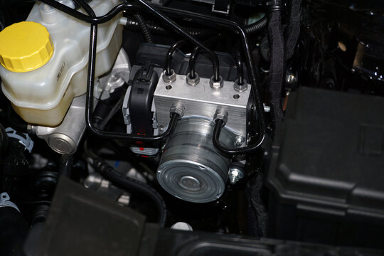 The control unit for the anti-lock braking system ABS of a modern car is installed in the engine compartment.