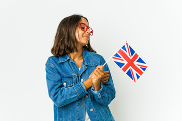 Young latin woman holding a english flag isolated on white background