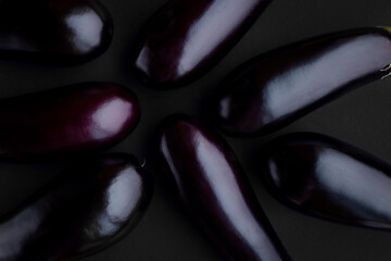Eggplant background minimalism. Vegetables trend top view flatlay. Total black. Deep violet. Low key. Dark. Vitamins health raw food vegan ingredient