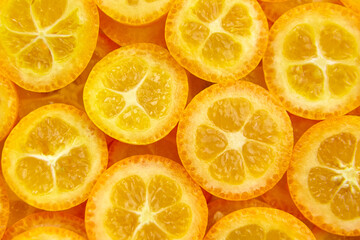 kumquat citrus fruit slices background