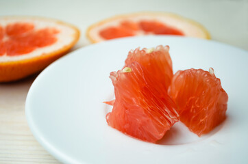 Grapefruit slice on a wooden background. The concept of vegetarianism and raw food.