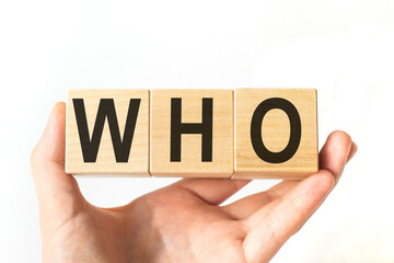 Hand holds wooden cubes with letters who. Business concept image.