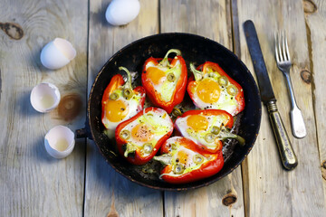 Selective focus. Frying pan with peppers stuffed with egg. The keto diet. Healthy lunch or breakfast.