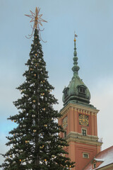 Royal castle clock tower and christmas tree in Warsaw old town