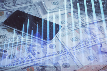 Fototapeta premium Double exposure of forex graph drawing over us dollars bill background. Concept of financial markets.