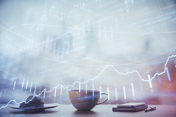 Double exposure of forex chart over coffee cup background in office. Concept of financial analysis...