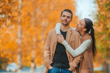 Fototapeta premium Happy family walking in autumn park on sunny fall day