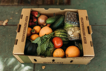 CSA farmers box full of produce on front porch