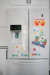 kitchen fridge with magnets and kid crafts