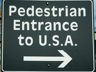 Close up of the crossing roadsign indicating pedestrian entrance to USA