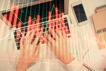 Double exposure of woman hands working on computer and forex chart hologram drawing. Top View. Financial analysis concept.