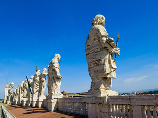 Fototapeta na wymiar Statues on the roof of St Peter's Basilica in Vatican