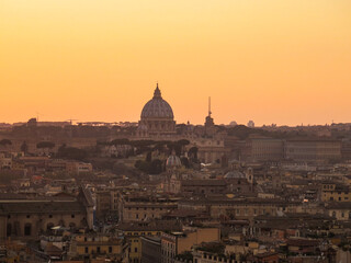 Fototapeta premium View of St Peter's basilica, as seen from Castel sant'Angelo, at golden hour, in Rome, Italy