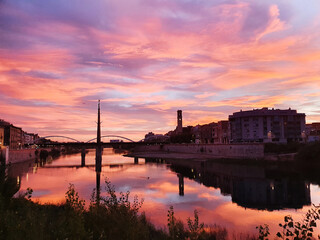 Colorful sunset with the clouds over the city