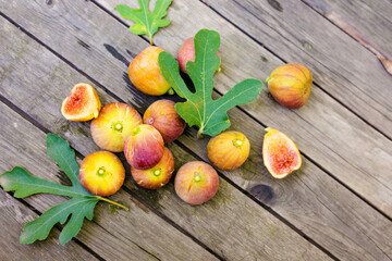 Fresh ripe figs on dark table. Healthy mediterranean fig fruit. Fresh figs on black background. Beautiful blue violet figs with empty copyspace close up.