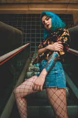 Portrait of a blue haired woman with tattoos. Tattoo.