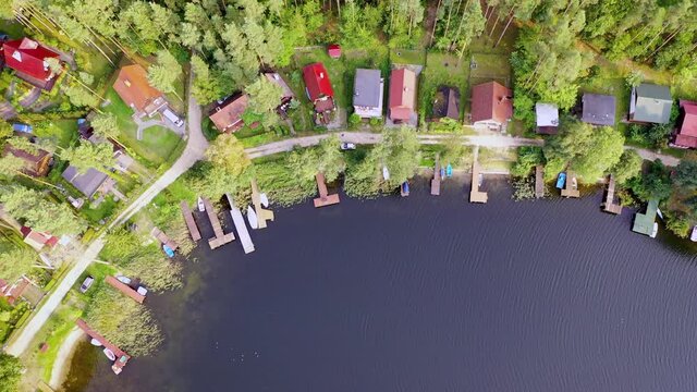 Summer houses over Narie lake in Kretowiny village, Warmia Mazury region of Poland - 4k drone video