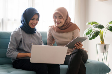 a portrait of a beautiful muslim woman who is very happy to see the results of her efforts with her partner