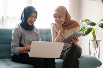 a portrait of a beautiful muslim woman who is very happy to see the results of her efforts with her partner