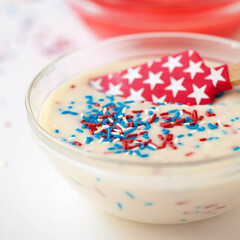 Red White Blue Patriotic Candy Sprinkles in Icing Cupcake Batter Glass Bowl with Stars on Spatula