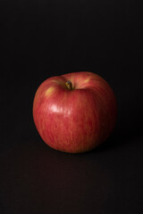 red apple on black background