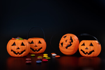 Four halloween plastic pumpkin with candy