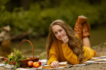 Cute teen girl falls in the woods with apple and ash