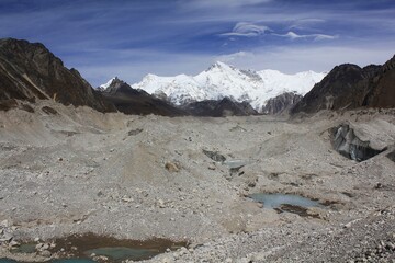 View from track through the longest glacier in Himalaya - Ngozumba Glacier near Gokyo, with scenic view of ice, Gokyo Ri and Cho Oyu - Everest Trek, Sagarmatha Khumbu, Nepal