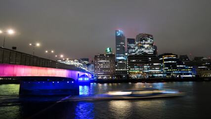 Fototapeta na wymiar Long exposure photography of London buildings and the Thames river at night