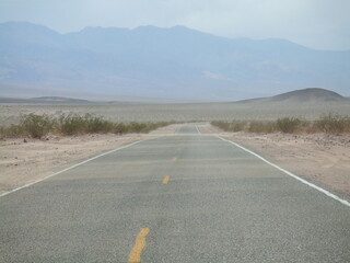 sand blowing across the road entering Death Valley