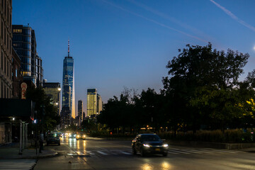 Fototapeta na wymiar New York / USA - October 15 2020: street view of financial district with one world trade center building at night