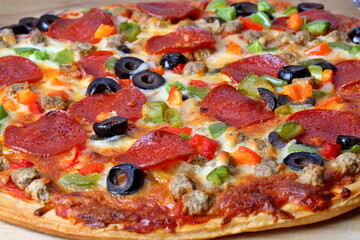 Delicious pizza with salami and vegetables
