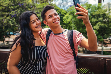 Young Couple of Smiling Students Making Selfie Outdoors.