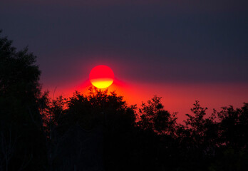Sunset with multiple hues of red, orange, purple and yellow because of wildfires in Riverside county, California in September 2020