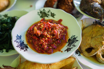 portrait of red chilli sauce on a plate on in a traditional food dish