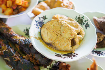portrait jangki fish yellow base on a plate on in a traditional food dish