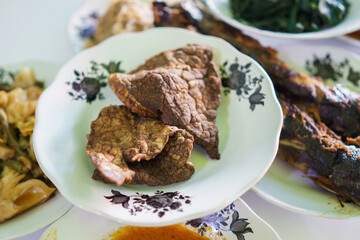 portrait fried beef lung food on a plate on in a traditional food dish