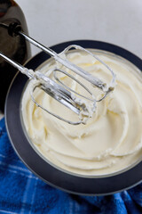 Fototapeta premium White cream for cake in bowl and mixer.