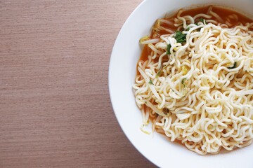 dry tomyum noodle on wooden table