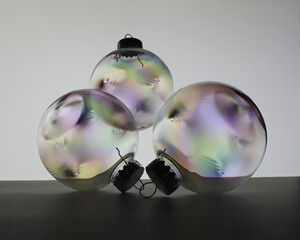 Three clear Christmas ornaments that I took a photo of  with my polarizer lens and a lit background.  The colorful parts shows where the plastic is weak.