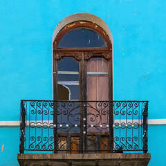 Weathered colonial style balcony with blue facade, Potosi, Bolivia.