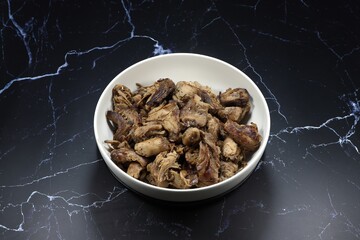 Traditional grilled mushroom stem or mushroom stipe with soy sauce and pepper in the bowl. Famous appetizer snack menu in Asia restaurant. Food in vegetarian festival concept. 