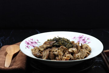 Fried and stirred cooked rice with spicy mushroom paste and topping with marinated cabbage and grilled mushroom stem(stipe) on the plate. Famous vegetarian menu in Asia restaurant. 
