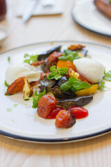 Fototapeta na wymiar Roasted eggplant, tomatoes and poached eggs