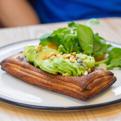 Flaky pastry topped with avocado