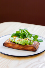 Flaky pastry topped with avocado