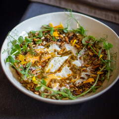 Baked eggs with puffed rice and herbs